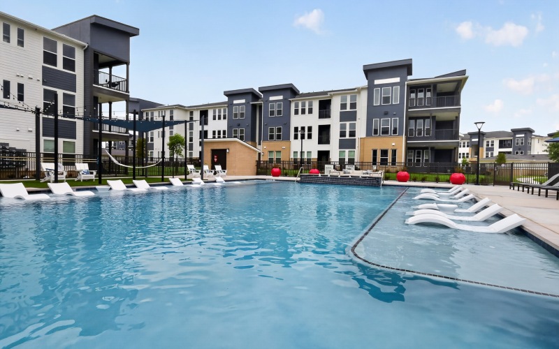courtyard with a pool and lounge chairs