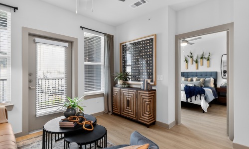 Bright, modern apartment interior at Aspire at Greenville featuring spacious living areas, large windows, and contemporary finishes.