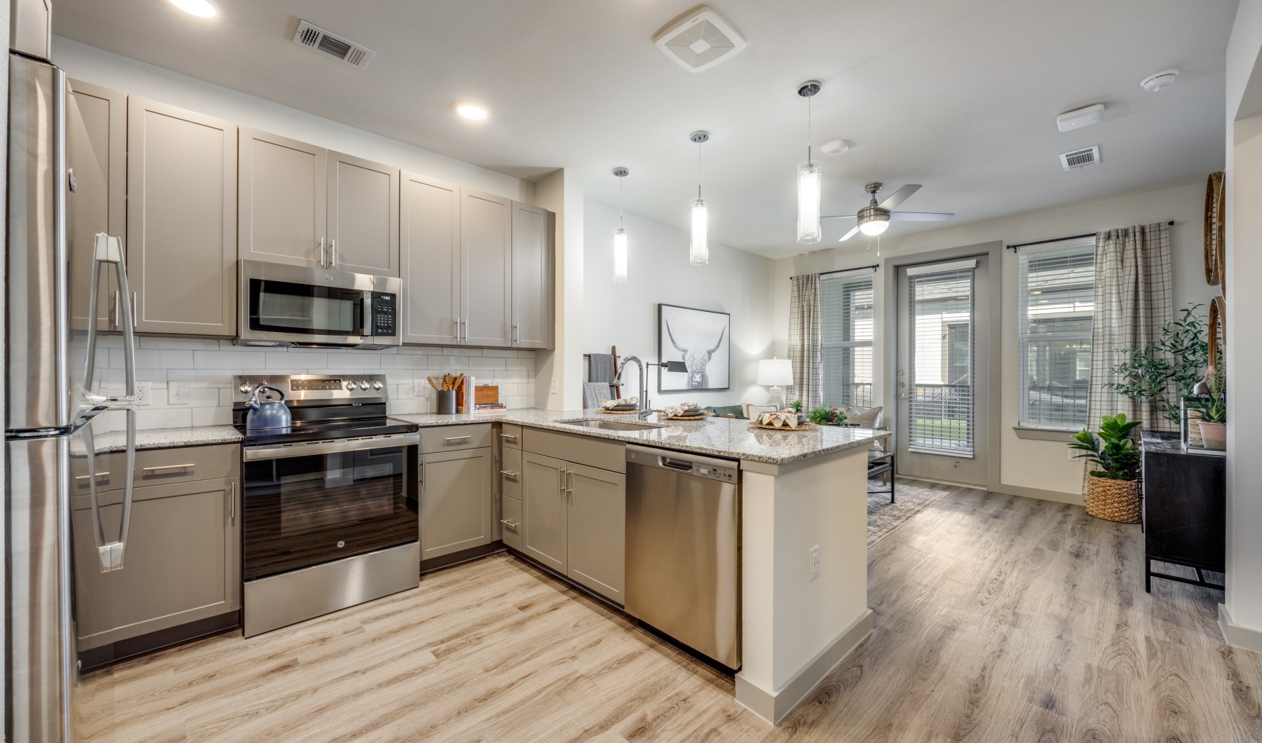 Kitchen with brown wood floors and grey cabinets