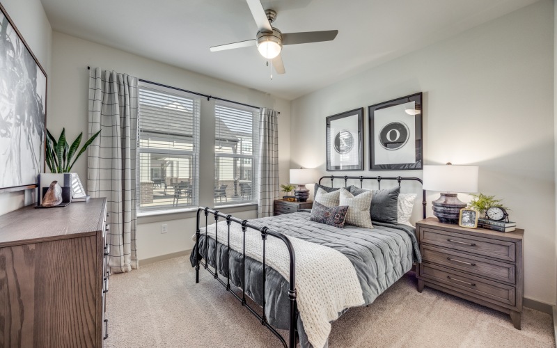 A room with a bed, a dresser, and a night stand