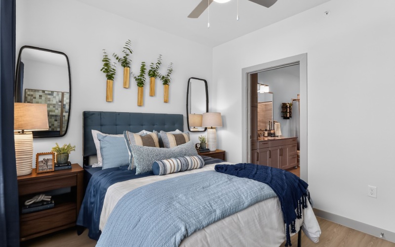 A room with a bed, a dresser, and a night stand